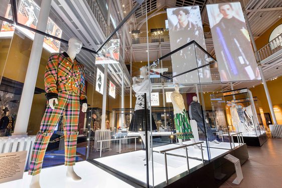 Mannequins wearing colourful clothes on display in a museum