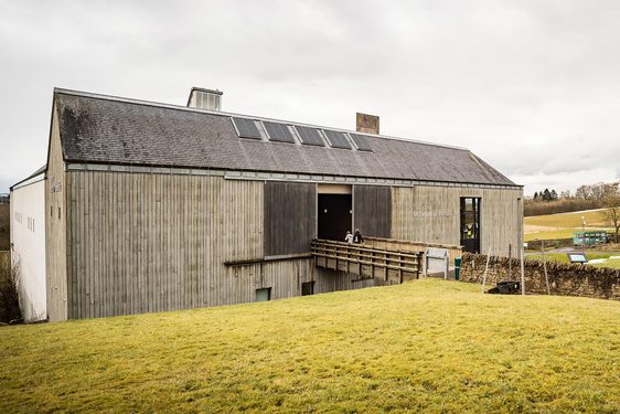 Two visitors walking through the entrance of the National Museum of Rural Life.