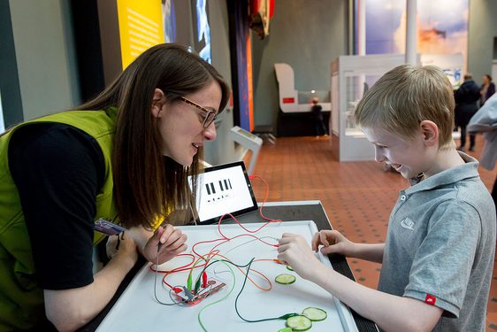 An adult helping a child with a science experiment
