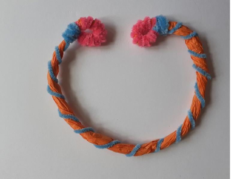 A handmade necklace crafted from colourful tissue paper and pipe cleaners.
